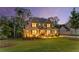 Stunning two-story home with exterior lighting, a stone entryway, and a well-manicured lawn at 771 Phil Haven Ln, Kennesaw, GA 30152