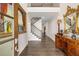 Elegant foyer with hardwood floors, staircase, decorative mirror, and artwork creating an inviting entryway at 771 Phil Haven Ln, Kennesaw, GA 30152