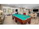 Spacious game room with a pool table, media area, and adjacent living room at 771 Phil Haven Ln, Kennesaw, GA 30152
