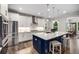 Modern kitchen featuring white cabinets, a stainless steel refrigerator, and a central island with bar seating at 771 Phil Haven Ln, Kennesaw, GA 30152