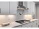 Bright kitchen features sleek white cabinets, stainless steel appliances, and a modern backsplash at 771 Phil Haven Ln, Kennesaw, GA 30152