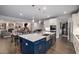 Open kitchen layout with a central island, white cabinetry, and seamless flow to the dining and living areas at 771 Phil Haven Ln, Kennesaw, GA 30152
