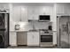 Updated kitchenette featuring stainless steel appliances and white cabinets at 771 Phil Haven Ln, Kennesaw, GA 30152