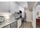 Well-lit kitchenette featuring granite countertops, stainless steel appliances, and white cabinets at 771 Phil Haven Ln, Kennesaw, GA 30152