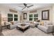 Cozy living room featuring a large sectional sofa, fireplace, and ample natural light at 771 Phil Haven Ln, Kennesaw, GA 30152