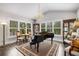 Bright living room with large windows, a piano, and elegant decor at 771 Phil Haven Ln, Kennesaw, GA 30152