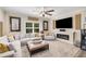Comfortable living room featuring a large sectional sofa, fireplace, and TV at 771 Phil Haven Ln, Kennesaw, GA 30152