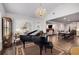 Bright living room with a piano, chandelier, and elegant decor at 771 Phil Haven Ln, Kennesaw, GA 30152