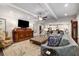 Open-concept living room with modern furnishings, hardwood floors, and a view to the kitchen at 771 Phil Haven Ln, Kennesaw, GA 30152