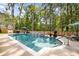 Backyard swimming pool with a stone waterfall feature, landscaping, and lounge chairs at 771 Phil Haven Ln, Kennesaw, GA 30152