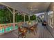 Outdoor porch with comfortable dining set and a view of the pool and backyard at 771 Phil Haven Ln, Kennesaw, GA 30152