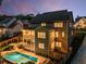Evening aerial view of the back of the house with pool and landscaped backyard at 771 Phil Haven Ln, Kennesaw, GA 30152