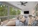 Relaxing sunroom with a ceiling fan, comfortable seating, and scenic outdoor views at 771 Phil Haven Ln, Kennesaw, GA 30152