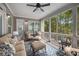 Cozy sunroom with ample seating offers picturesque views of the surrounding greenery at 771 Phil Haven Ln, Kennesaw, GA 30152