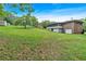 Serene backyard featuring lush greenery, a brick house, a detached garage, and room for outdoor enjoyment at 14 Connie St, Cartersville, GA 30121