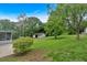 Expansive backyard featuring lush greenery, a detached garage, and a glimpse of the screened-in porch at 14 Connie St, Cartersville, GA 30121