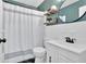 Bathroom featuring elegant fixtures, a shower with a curtain, and a wall-mounted round mirror at 14 Connie St, Cartersville, GA 30121