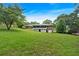 Picturesque backyard with expansive lawn, brick house, and detached garage, perfect for outdoor living at 14 Connie St, Cartersville, GA 30121