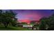 Beautiful home exterior with a vibrant sunset backdrop, complemented by lush trees and an expansive lawn at 14 Connie St, Cartersville, GA 30121