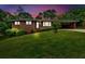 Charming brick home with a well-manicured lawn and covered carport at dusk at 14 Connie St, Cartersville, GA 30121