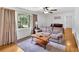 Sunlit living room featuring hardwood floors, gray sofa, and a large window at 14 Connie St, Cartersville, GA 30121