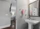 Charming powder room with a pedestal sink and decorative mirror at 1582 Cambridge Pl, Marietta, GA 30062