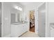 A bathroom vanity features granite countertop, white cabinets, and access to walk-in closet at 1582 Cambridge Pl, Marietta, GA 30062