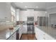 Bright kitchen featuring granite countertops, stainless steel appliances, and white cabinetry at 1582 Cambridge Pl, Marietta, GA 30062