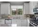 Bright kitchen featuring granite countertops, stainless steel appliances, and white cabinetry at 1582 Cambridge Pl, Marietta, GA 30062