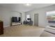 Spacious carpeted living room with natural light, modern television and gray sofa at 1582 Cambridge Pl, Marietta, GA 30062