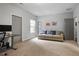 Comfortable carpeted living room with natural light, gray sofa, desk and neutral tones at 1582 Cambridge Pl, Marietta, GA 30062