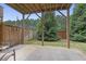 Outdoor patio area with stone floor, privacy fence, and mature trees at 1582 Cambridge Pl, Marietta, GA 30062