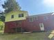 Backyard of a split level home, with a red deck and stairs at 801 Needle Rock Dr, Stone Mountain, GA 30083