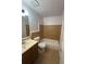 Bathroom features a tub with nice tiling, light fixture and updated vanity at 801 Needle Rock Dr, Stone Mountain, GA 30083