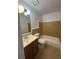 Bathroom features a tub with nice tiling, light fixture and updated vanity at 801 Needle Rock Dr, Stone Mountain, GA 30083