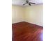 Bedroom with hardwood floors, yellow walls, a ceiling fan, and natural light at 801 Needle Rock Dr, Stone Mountain, GA 30083