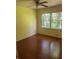 Bedroom with hardwood floors, yellow walls, large windows, and natural light at 801 Needle Rock Dr, Stone Mountain, GA 30083