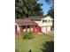 Charming two-story home with a brick facade, a well-maintained lawn, and double garage doors at 801 Needle Rock Dr, Stone Mountain, GA 30083