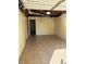 A well-lit garage space with tiled flooring and exposed ceiling fixtures at 801 Needle Rock Dr, Stone Mountain, GA 30083