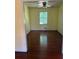 Living room with hardwood floors, ceiling fan, large windows, and natural light at 801 Needle Rock Dr, Stone Mountain, GA 30083
