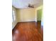 Living room with hardwood floors, yellow walls, ceiling fan, and a window with natural light at 801 Needle Rock Dr, Stone Mountain, GA 30083