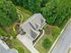 Aerial image showing the house surrounded by landscaped lawns, trees, and a paved driveway at 111 Millstone Way, Canton, GA 30115