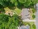 Stunning aerial view showcasing a beautifully landscaped backyard with a patio and lush green trees at 111 Millstone Way, Canton, GA 30115