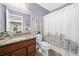 Bathroom featuring granite vanity, patterned shower curtain, and coordinating wall decor at 111 Millstone Way, Canton, GA 30115