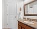 Bathroom vanity with a granite countertop and sink. Brown wood cabinets and a mirror on the wall at 111 Millstone Way, Canton, GA 30115