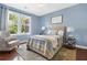 Cozy bedroom featuring a queen bed, stylish decor, and ample natural light from a large window at 111 Millstone Way, Canton, GA 30115