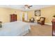 Bright bedroom featuring hardwood furniture, ceiling fan, and stylish seating arrangement at 111 Millstone Way, Canton, GA 30115