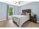 Cozy bedroom featuring a bed with a plaid quilt, a nightstand, and soft, natural lighting at 111 Millstone Way, Canton, GA 30115