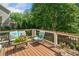 Relaxing deck area with comfortable outdoor seating and a view of backyard trees at 111 Millstone Way, Canton, GA 30115