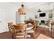 An eat-in dining area featuring a round table and chairs situated adjacent to a cozy Gathering room with fireplace at 111 Millstone Way, Canton, GA 30115